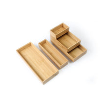 Natural bamboo drawer organizer set with three long trays and a raised cup section