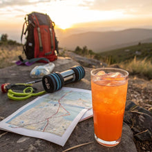 Orange energy drink in a glass with ice, made from energy mix
