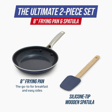 Ceramic nonstick frying pan with silicone-tipped wooden spatula and metal handle