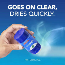Solid balm stick applicator in hand with blue lid and vapor swirls
