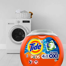 Tide PODS Ultra OXI laundry detergent tub in front of a white washing machine