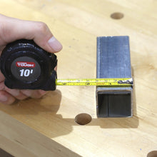 10 ft tape measure measuring a wooden board alongside a metal measuring square