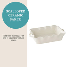Scalloped white ceramic baking dish with wavy rim and rectangular form
