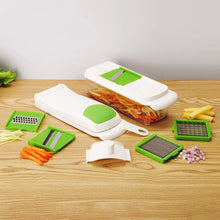 Multi-function mandoline slicer with green blade inserts and white housing, with tools