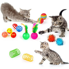 Assorted cat toy balls and spring toys with rainbow track ball and fuzzy pom