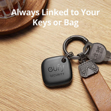 Black key finder tags on a keyring with metal and leather straps