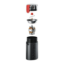 Electric coffee grinder with hopper removed, showing blade assembly and red button