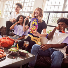 Takis Fuego chips bag held by people during a casual gathering