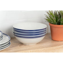 Stacked white ceramic bowls with blue striped bands