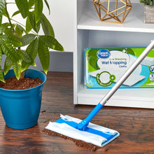Wet mopping cloths on floor with blue-handled mop