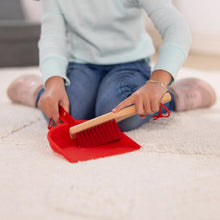 Red dustpan with wooden brush and white bristles for pretend sweeping