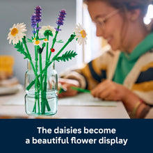 Daisy building model in a glass jar with white daisies, purple lavender stems, and leaves