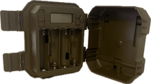 Tan trail camera with open back showing battery compartment inside