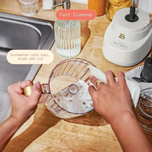 Drew Barrymore 3-cup food chopper beside a clear lid and blade for easy cleanup
