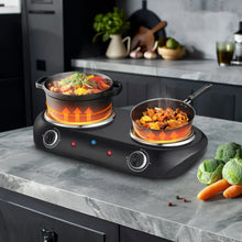 Black electric double-burner cooktop with two hotplates and orange heat rings under pans.