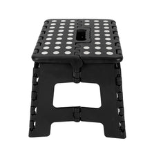Foldable plastic step stool, black, closed frame with dot-pattern top and foldable platform