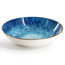 Blue porcelain serving bowl with speckled glaze and thin gold rim