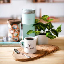Cameron's coffee mug with brewed coffee on wooden tray with spoon