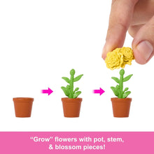 Grow flower pieces: yellow blossom and green stem in orange pots, hand assembling
