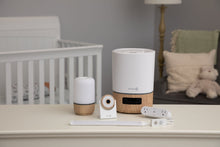 White dual smart outlet on tabletop with nearby smart devices and plugs