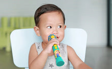 Baby holding a teal sing-along microphone close to their mouth