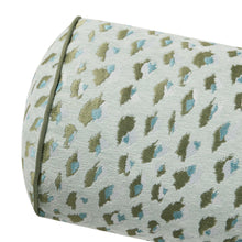 Woven leopard print bolster pillow cover detail, off-white with green and blue spots.