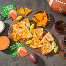 Assorted tortilla chips and snack nachos with dips and lime wedges