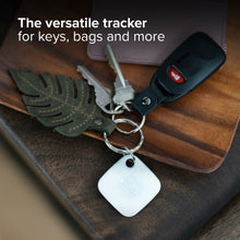 White Bluetooth tracker tag on a keyring with a leather key fob