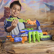 Transforming robot action figure with green and blue armor, held in a child’s hands