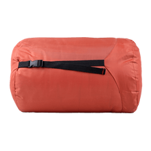 Sleeping bag compression sack in coral-red with black carry strap