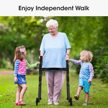 Black folding walker with wheels used outdoors by a senior