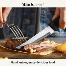 Black-handled serrated steak knife cutting on a wooden board