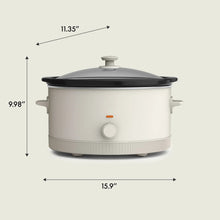 bella 6 Qt slow cooker with white base, black lid, and control knob