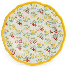 Dinner plate with white center and multicolor small flowers, framed by yellow rim