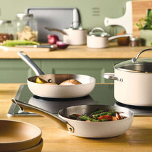 Stainless steel frying pan and saucepan set with black handle accents
