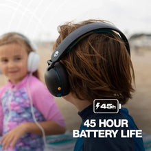 Child wearing black over-ear headphones with teal details
