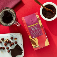 bettergoods ground coffee pouch with cup of coffee and chocolate pieces nearby