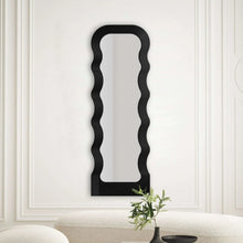 Large floor mirror with black wavy frame and tall arched mirror panel