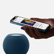 HomePod mini smart speaker in blue, with glowing light ring on top