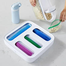 White plastic food bag dispenser with four colored roll slots and open top