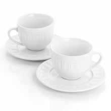 White ceramic mugs with embossed texture and matching saucers