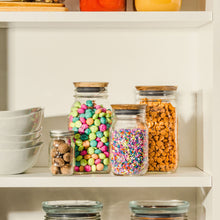 Ball wide-mouth mason jars with metal lids and bands, filled with colorful candies.