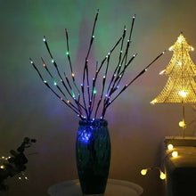 Colorful LED-lit willow branches with multicolor glow in a vase