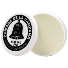 Pomade jar with open lid showing pale cream inside