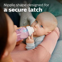 Baby with pink Philips Avent anti-colic bottle, clear nipple in use