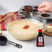 McCormick Pure Vanilla Extract bottle pouring into a mixing bowl