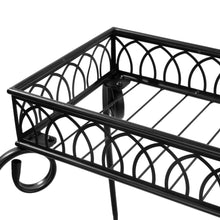 Black metal plant stand top shelf with decorative lattice rails and side scroll supports.