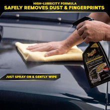 Meguiar's Gold Class Quik Detailer spray bottle and microfiber cloth on car surface