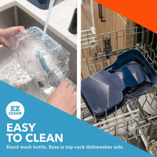 Navy gravity pet waterer with clear bottle being filled and cleaned