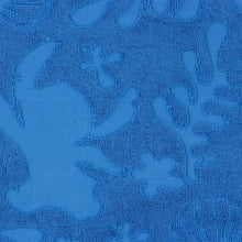 Blue hooded towel fabric texture with raised plush looped terry and animal print